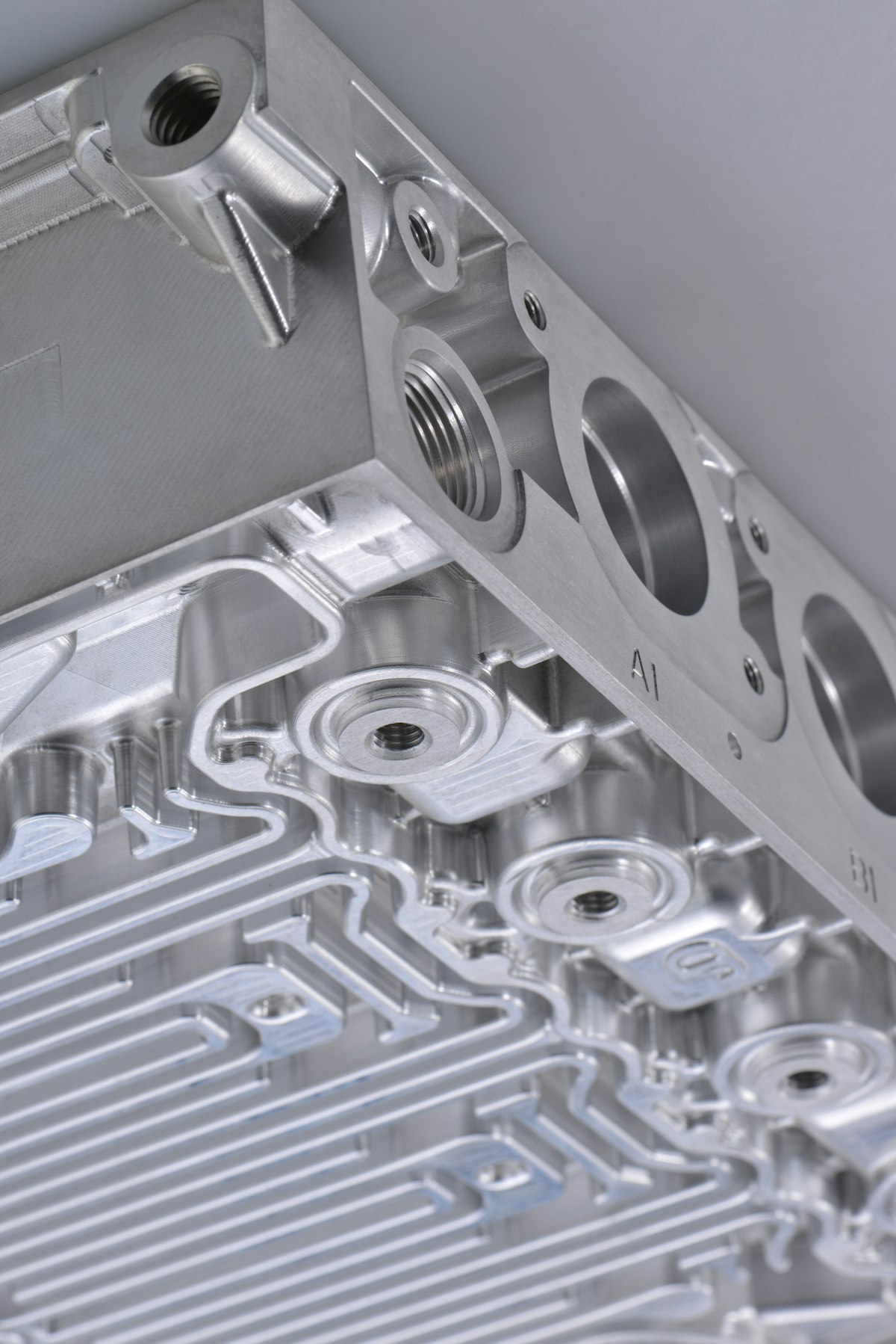 Machined aluminium fixture block with precision bores and mounting faces